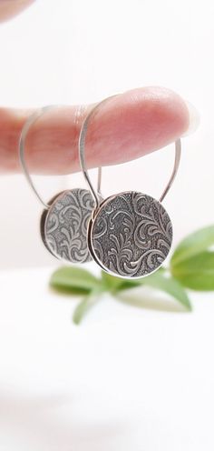 "These sterling silver padlock-style earrings measure 5/8\" in diameter and are cupped like my square padlock-style earrings. This is a great variation on the padlock design. One side features a silver spiral pattern, the other a silver vines pattern. The overall height of these is 1 1/8\" and the ear wire is made from a sturdy 19 gauge sterling that will hold its shape with everyday wear. My padlock earrings are reversible: you can wear them with one pattern showing, turn them around to the oth Silver Etched Earrings As A Gift, Silver Etched Earrings For Gifts, Etched Hoop Earrings As Gift, Etched Dangle Earrings As Gift, Dangle Etched Earrings As Gift, Elegant Etched Round Earrings, Etched Dangle Earrings For Gift, Elegant Etched Dangle Earrings, Silver Etched Round Earrings