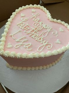 a heart shaped birthday cake with the words happy birthday written in frosting on it