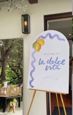 a welcome sign is displayed in front of the door to a house that has been decorated with lemons and grapefruits