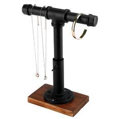 a black metal and wood stand with two rings on it's end, one ring is hanging from the top