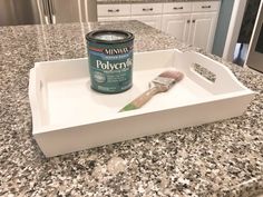 a can of paint sitting on top of a white tray