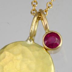 "Beautifully crafted Ruby and 14ky gold pendants on a 16\" 14ky gold chain. Hammered disc is about 1/2 of an inch in diameter. AA grade Ruby is 3mm. Very contemporary, classy, and timeless. Birthstone for July. Comes with a lifetime warranty, polishing cloth, and a gift box." Yellow Gold Charm Necklace With Round Pendant, Hammered Yellow Gold Round Disc Jewelry, 14k Yellow Gold Birthstone Necklace With Round Pendant, Round Hammered Fine Jewelry Necklaces, Round Hammered Fine Jewelry Necklace, Yellow Gold Hammered Round Charm Necklace, Tarnish Resistant Yellow Gold Round Disc Charm Necklace, Elegant Round Hammered Charm Necklaces, Yellow Gold Tarnish Resistant Birthstone Necklace