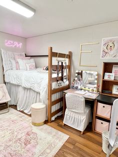 a bedroom with a bed, desk and chair in it next to a rug on the floor