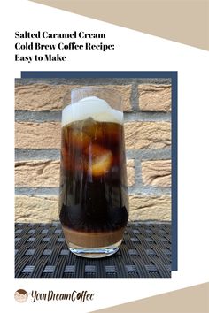 a glass filled with liquid sitting on top of a table