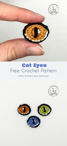 a hand holding a small crochet cat eye brooch with two different colored eyes