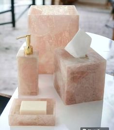 pink marble soap dispenser, soap dish and tissue holder on a white table