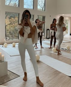 a woman taking a selfie in a yoga class