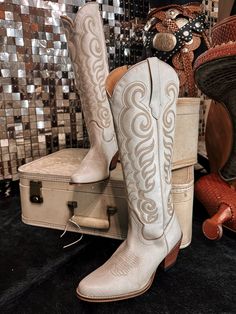 Embrace effortless Western elegance with these breathtaking boots. Crafted from buttery-soft suede in a dreamy, cloud taupe hue, they feature exquisite Western embroidery that adds a touch of authentic charm to the smooth, supple surface. The classic cowboy boot silhouette, with its pointed toe and stacked heel, provides both style and comfort. Perfect for dressing up or down, these versatile boots will become a go-to in your footwear collection. Express your awesome Western-inspired fashionista White Boots For Western-themed Events, Chic Leather Boots For Western-themed Events, Cream Leather Heeled Boots With Snip Toe, Cream Leather Snip Toe Heeled Boots, Beige Suede Snip Toe Boots, Fitted White Boots For Country Events, Elegant Snip Toe Boots For Western-themed Events, White Round Toe Boots For Country Events, Western Beige Leather Heeled Boots