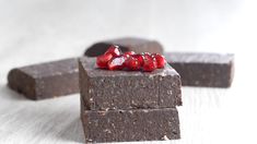 two pieces of chocolate with red candy on top