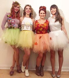 three girls in costumes standing next to each other with their hands on their hipss