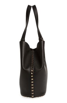 Iconic pyramid studs punctuating the sides and shoulder straps add edge to a softly structured tote made in Italy from richly grained calfskin leather. Flip-lock closure Shoulder straps Lambskin-leather lining Leather Made in Italy Designer Handbags Lambskin Leather, Valentino Garavani, Pyramid, Leather Tote, Shoulder Straps, Designer Handbags, Calf Skin, In Italy, Nordstrom