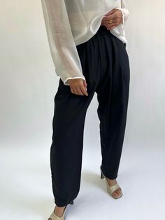 The Lena Pant is our classic go-to pant, essential and styles virtually across every piece from our In-House Line. The Lena Pant features a comfortable elastic waist, handsome front pleats, side pockets, with a slightly tapered leg. We love pairing the Lena Pant in silk herringbone with our coveted Mary Margaret Top that truly makes for a day to evening affair look! Our Silk Herringbone fabrication shares a stunning textural quality that's reminiscent of our absolute favorite vintage menswear pi Chic Pull-on Style Bottoms For Daywear, Elegant Bottoms With Gathered Waist For Daywear, Loosely Fitted Trousers With Pleated Waist, Casual Ankle-length Pants With Gathered Waist, Elegant Wide Leg Pull-on Pants For Work, Trousers With Pleated Waist And Loosely Fitted Hips, Relaxed Fit Bottoms With Pleated Waist And Wide Leg, Relaxed Fit Wide Leg Bottoms With Pleated Waist, Chic Solid Color Tapered Leg Bottoms