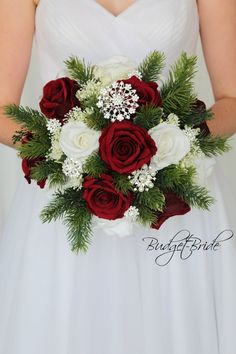 a bridal holding a bouquet of red and white flowers