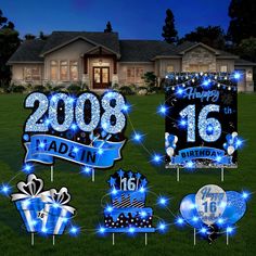 blue and white birthday yard decorations in front of a house at night with lights on