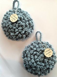 two crocheted balls with tags attached to them