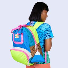 This item, once sold out, will be discontinued and will not return. The Camp Kawaii colorway is being discontinued and will not return once the remaining items have sold. The ultimate go-to style. Mid-size backpack with a large wide-open front zipper pocket. 3D pockets on both sides to stash your umbrella or water bottle. Webbing tote handles featuring easy grab front and back strap with matching logo snap. Inside zipper pocket and back suitcase trolley sleeve for easy travel. Adjustable padded Nylon Backpack With Water Bottle Pocket For Trip, Retro Standard Backpack For Back To School, Playful Nylon Backpack, Retro Outdoor Backpack, Retro Green Backpack For Travel, Green Backpack With Removable Pouch For School, Multicolor Backpack With Zipper Pocket For School, Multicolor Backpack With Zipper Pocket For Back To School, Multicolor Backpack With Removable Pouch