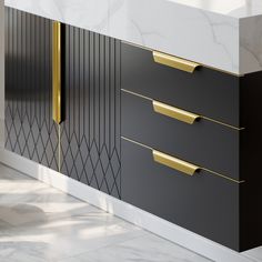 a black and white cabinet with gold handles in a room that has marble flooring