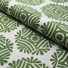 a green and white wallpaper with leaves on it