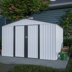 a small white shed sitting in the middle of a yard