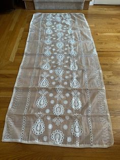 This is a creme, semi-sheer, intricately embroidered, pure, soft Khaadi (hand spun cotton) shawl scarf stole dupatta. The soft, cotton-rich, handwoven material has a sophisticated sheen to it. It has tone-to-tone embroidered floral and paisley motifs dispersed throughout the dupatta.  These motifs are embellished with silver foil mirrors. There is a creme lace on all four sides.. This is a dreamy item that is beautiful, luxurious, decadent, and charming.  MATERIAL =soft Khaadi net ...this is a s Cream Lace Work Dupatta, Cream Lace Dupatta With Lace Work, Festive Embroidered White Lace, Festive White Embroidered Lace, White Bohemian Embroidered Fabric For Eid, White Embroidered Fabric With Lace Work For Eid, White Bohemian Lace Dupatta, Bohemian Lace Dupatta With Lace Work, Bohemian White Lace Dupatta