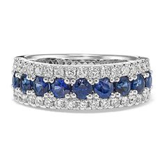 a white gold ring with blue sapphires and diamonds on the sides, set in 18k white gold