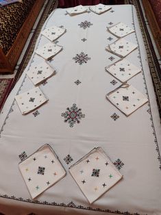 the table cloth is laid out with napkins on it