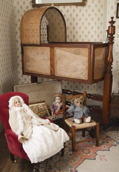 an old fashioned doll house with teddy bears on the floor and furniture in front of it