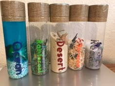 four different types of salt and pepper shakers lined up on top of a table