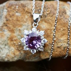 "Handmade Lab Created Nano Color Change Alexandrite - 8mm 2.9 Carat 18\" Sterling Silver Chain Cubic Zirconias Solid Sterling Silver 925 Pendant measures 19mm .79\" long from top of bale The alexandrite in the pendant is just gorgeous! It will change color from purple to fuchsia depending on the light. I've take pictures in different lighting so you can see the color change. There are sparkling cubics set all around the alexandrite so this really sparkles. These can be made up for you in solid white, yellow or rose gold. Just get ahold of me for a free estimate. Custom orders take around 6 - 8 weeks. Care : Store all your sterling silver and vermeil jewelry in plastic baggies to slow down tarnish. Don't let your sterling silver jewelry come in contact with chlorine. It can permanently tarn Cubic Zirconia Gemstones With Center Stone, Round Cubic Zirconia Fine Jewelry Gemstones, Fine Jewelry Cubic Zirconia Round Gemstones, Fine Jewelry Cubic Zirconia Gemstones, White Gold Cubic Zirconia Gemstones With Halo Setting, Cubic Zirconia Gemstones With Halo Setting, Dazzling Cubic Zirconia Gemstones With Halo Setting, Cubic Zirconia Round Cut Necklace With Center Stone, Silver Diamond Necklaces With Center Stone