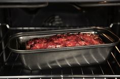 an oven with meat cooking in it