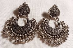 Beautiful Jhumkas One of a kind Very well made and beautiful Excellent condition These hang 2.5 inches Very beautiful design Rustic silver color Handmade and sturdy Silver Temple Jewelry Chandelier Earrings With Intricate Design, Silver Temple Jewelry Chandelier Earrings With Latkans, Ornate Silver Chandelier Earrings For Festivals, Heavy Silver Round Chandelier Earrings, Festive Silver Nickel-free Chandelier Earrings, Festive Nickel-free Silver Chandelier Earrings, Handmade Silver Chandbali Chandelier Earrings, Silver Chandbali Chandelier Earrings, Handmade Silver Temple Jewelry Chandelier Earrings