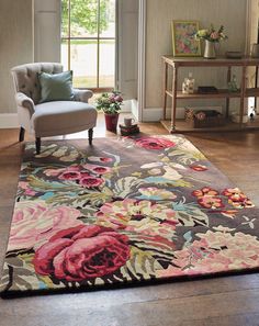 a living room with a floral rug and chair