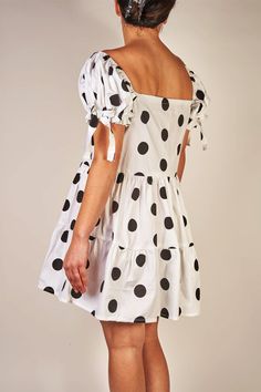 An editorial and classic style dress that makes a statement. Oversized black polka dots printed on woven cotton with a hint of stretch. Gathered detailing on sleeves and skirt. Fits a size Medium. MEASUREMENTS: Chest: 36 inches chest circumference Waist: 28 inches Body Length: 35 inches from shoulder, 16 inches from waist seam FABRICATION: Cotton/elastane blend Handcrafted in New York. Please Note: This piece is a one-of-a-kind sample and is final sale. Casual Polka Dot Square Neck Dresses, Chic Polka Dot Cotton Dress, Chic Cotton Polka Dot Dress, Chic A-line Mini Dress In Polka Dot, Chic A-line Mini Dress With Polka Dots, Polka Dot Ruffled Dresses For Daywear, Polka Dot Dress With Ruffles For Daywear, Polka Dot Fitted Mini Dress For Daywear, Fitted Polka Dot Mini Dress For Daywear