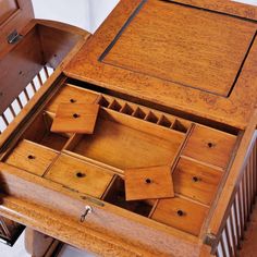 an old wooden desk with drawers on the top and bottom drawer open to show what's inside