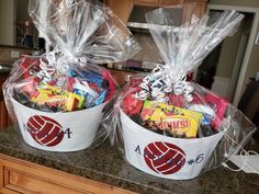 two buckets filled with candy sitting on top of a counter