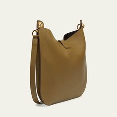 TOM FORD "Tara" crossbody hobo bag in leather, faux leather (polyurethane), and brass  Adjustable, detachable flat crossbody strap Open top with T-strap magnetic closure; zip closure  Lining: Polyurethane Approx. 15"H x 15.7"W x 1.6"D Item Weight (Lbs.): 1.9 Made in Italy Modern Crossbody Hobo Bag With Gold-tone Hardware, Versatile Hobo Bag With Gold-tone Hardware For Work, Office Crossbody Hobo Bag With Metal Hardware, Workwear Hobo Bag With Metal Hardware Crossbody, Modern Crossbody Hobo Bag With Metal Hardware, Versatile Leather Hobo Bag With Gold-tone Hardware, Leather Hobo Bag With Metal Hardware For Work, Versatile Leather Hobo Bag With Metal Hardware, Hobo Crossbody Bag