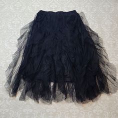 This Skirt Is New And Unworn. It Features An Elastic Waist And, A Rough Cut Tulle Layer Over A Solid Black Layer. It Doesn't Flare Too Much. It Would Be Great For Costumes, Concert Outfits, And More! Black Flowy Petticoat For Spring, Spring Black Flowy Petticoat, Spring Black Petticoat, Black Pleated Petticoat For Summer, Black Tiered Skirt Petticoat For Summer, Spring Black Lined Petticoat, Black Lined Petticoat For Summer, Black Lined Summer Petticoat, Black Skirted Summer Petticoat