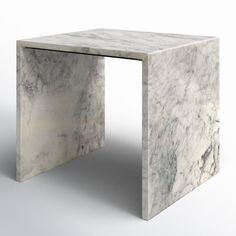 a white marble table sitting on top of a floor