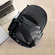 Our re-designed Classic Backpack now has ample space for a 15" laptop, and we've even given it it's own padded laptop compartment so you can stay organised. We've also added two external water bottle holders, complete with a waterproof lining, and a handy leather strap on the back that slots over wheelie suitcase handles so you can give your back a rest when you're on the go. -handmade to order -30 day money-back guarantee. $1.50 from every sale is donated to FRANK Water. Leather School Bag, Handmade Leather Backpack, Gym Backpack, Suitcase Handle, Work Backpack, City Backpack, Sustainable Leather, Vintage Leather Bag, Black Travel