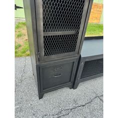 an old metal cabinet sitting on the sidewalk