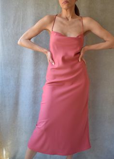 "Slip midi dress with adjustable criss cross back straps featuring a cowl neck in pink berry color. Mid calf length. Lightweight non-stretchy fabric. Model is (172 cm - 5'8\") and (53 kg - 117 lbs) and is wearing size S Handmade in Bali Composition: 100% Viscose" Fitted Midi Slip Dress With Ruched Back, Spring Fitted Slip Dress With Cowl Back, Fitted Bias Cut Midi Dress With Cowl Neck, Elegant Pink Midi Dress With Adjustable Straps, Spring Slip Dress With Bias Cut And Cowl Back, Summer Midi Dress Bias Cut With Cowl Back, Chic Spring Slip Dress With Ruched Back, Spring Fitted Midi Dress With Cowl Back, Fitted Midi Dress With Cowl Back For Spring