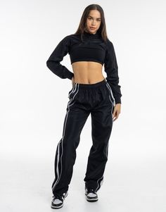 Meet the High Cut Hoodie, the perfect layering piece that deserves to be a part of the all-year rotation. The ultra cropped length is the High Cut Hoodie's best attribute, great for showing off your sportsbra and/or bikini. Add in a hoodie and you've got a top that can provide style and warmth - Super soft cotton/polyester blend - In-trend ultra cropped silhouette - Large hood - Designed to flatter every size - Worn by our inhouse team for the perfect fit 62% Cotton, 38% Polyester Bella is weari Fitted Athleisure Track Jacket For Jogging, Black Nylon Sports Crop Top, Black Nylon Sporty Crop Top, Black Hip Hop Activewear For Gym, Black Sporty Nylon Crop Top, Sporty Black Nylon Crop Top, Winter Cropped Stretch Activewear, Sporty Cropped Crop Top For Streetwear, Black Nylon Crop Top For Sports