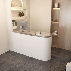 a white reception desk in an office with shelves and vases on the wall behind it