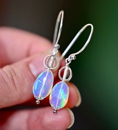 The Royal Earrings are so stunning you will feel the magic they hold inside of them. These are created with the most beautiful natural Ethiopian Opals with a blue and purple tone and rainbow flashes inside. These have gorgeous hoops and accent beads. The metal is all solid .925 sterling silver. These fabulous earrings dangle 2” down so they are perfect for wearing even when your hair is long and down. Royal Earrings, Purple Tone, Opal Earrings, Earrings Dangle, Ethiopian Opal, Solid 925 Sterling Silver, The Magic, Blue And Purple, Most Beautiful