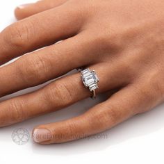 a woman's hand with a diamond ring on it