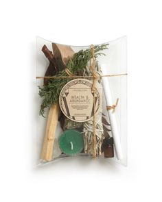 an assortment of herbs and candles in a clear package