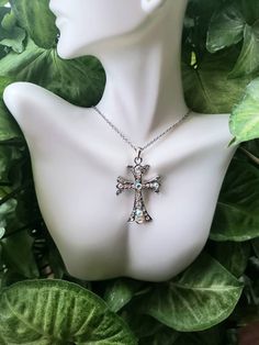 Cross necklace with iridescent rhinestones on a stainless steel chain. Choose length at checkout Silver Rhinestone Stainless Steel Jewelry, Silver Stainless Steel Jewelry With Rhinestones, Crystal Cross Pendant Necklace With Bling, Crystal Rhinestone Cross Necklace As Gift, Crystal Rhinestone Cross Necklace For Gift, Silver Crystal Cross Pendant Necklace, Crystal Rhinestone Cross Necklace Perfect For Gifts, Silver Rhinestone Pendant Necklace, Gift Crystal Rhinestone Cross Necklace