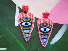 These pink evil eye heart earrings would make a perfect and unique gift for family, friend, or yourself. ★Weight of one earring is 0.015 lb If you like these bead embroidered earrings, but would like them in a different color please email me because I do special orders. ★READY TO SHIP Made with love and care about you!♥ ★DIMENSIONS: 8*4 cm ( 3.14 * 1.57 Inches) ★The colors can slightly differ from the photo because of photography lighting and monitor settings. ★ESTIMATED SHIPPING TIMES: North Am Fun Pink Heart-shaped Jewelry, Handmade Trendy Heart Drop Earrings, Trendy Handmade Heart Drop Earrings, Pink Beaded Heart Earrings For Party, Pink Bohemian Jewelry With Evil Eye Detail, Bohemian Pink Earrings With Heart Beads, Pink Bohemian Evil Eye Jewelry, Pink Heart-shaped Beaded Earrings For Parties, Handmade Pink Heart Dangle Earrings