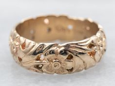 a close up of a gold ring on a white surface