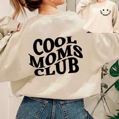 The Cool Moms Club Sweatshirt is the perfect choice for your special mom or new mom this Mothers Day! Our Cool Mom Sweatshirt is the perfect gift for any occasion. The sweatshirt features a unique design that any mom will appreciate. It's sure to bring a smile to her face and show her how much you care. The quality of our fabric is unmatched, so she can wear it day after day and stay comfortable no matter the weather. Show your mom how much you love her with a gift from the Cool Moms Club. A uni Crew Neck Cotton Hoodie For Mother's Day, Crew Neck Cotton Hoodie, Trendy Letter Print Sweatshirt For Mother's Day, Trendy Cotton Sweatshirt For Mother's Day, Casual Slogan Sweatshirt For Mother's Day, Casual Text Print Sweatshirt For Mother's Day, Casual Mother's Day Slogan Sweatshirt, Mother's Day Cotton Sweatshirt With Slogan, Casual White Sweatshirt For Mother's Day